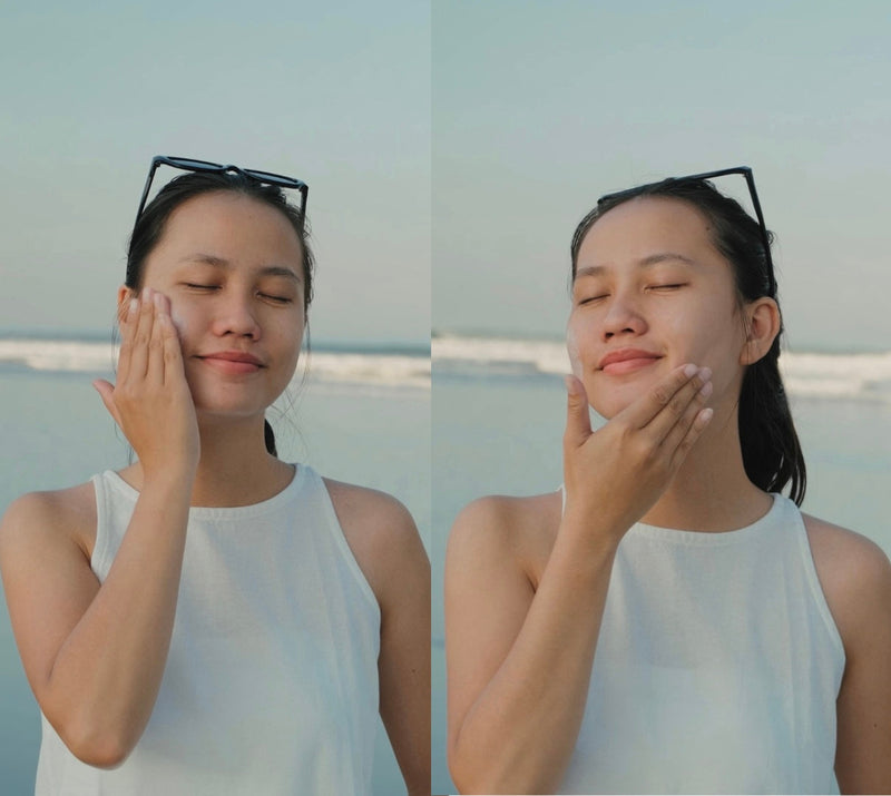 Woman applying sunscreen outdoors to protect her skin from UVA and UVB rays under natural sunlight.